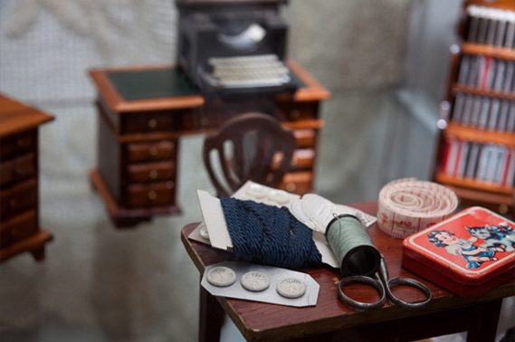 Tailor's desk with buttons, thread, scissors and a measuring tape